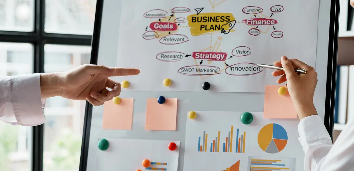 business people pointing at chart